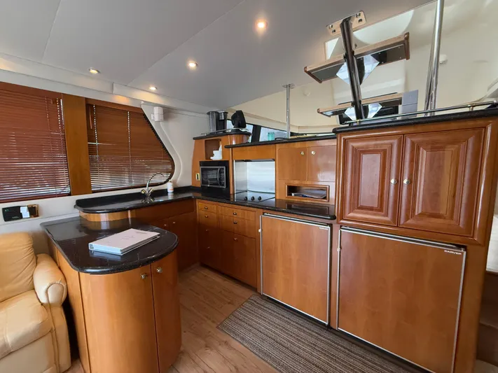  Yacht Photos Pics Luxurious kitchen interior of 2002 Carver 530 Voyager Pilothouse yacht with wooden cabinetry.