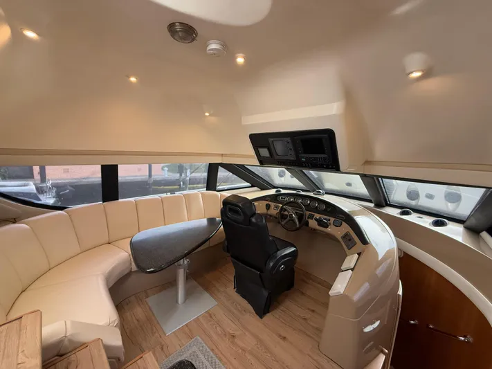  Yacht Photos Pics Luxurious interior of 2002 Carver 530 Voyager Pilothouse with helm and seating area.