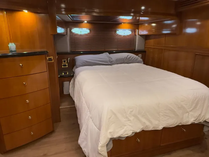  Yacht Photos Pics Luxurious bedroom interior of 2002 Carver 530 Voyager Pilothouse yacht with wood paneling.