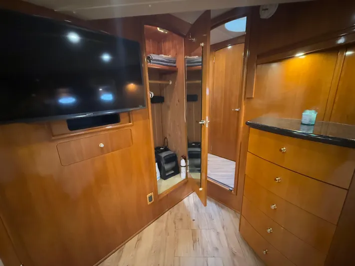  Yacht Photos Pics Interior of 2002 Carver 530 Voyager Pilothouse with wood cabinetry and mounted TV.
