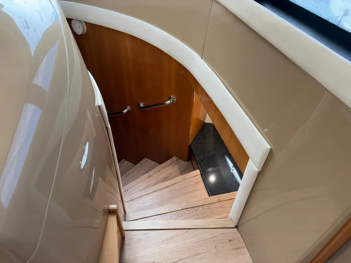  Yacht Photos Pics Staircase inside 2002 Carver 530 Voyager Pilothouse yacht, featuring elegant wood and sleek design.