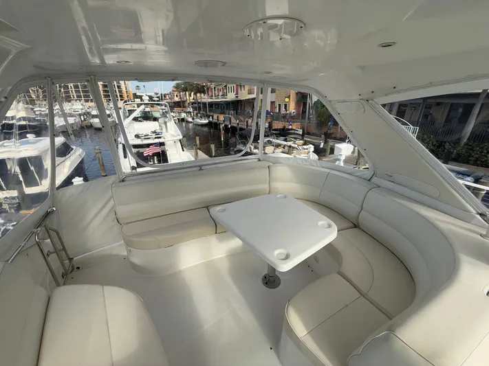 Yacht Photos Pics 2002 Carver 530 Voyager Pilothouse interior with white seating and table, docked at marina.