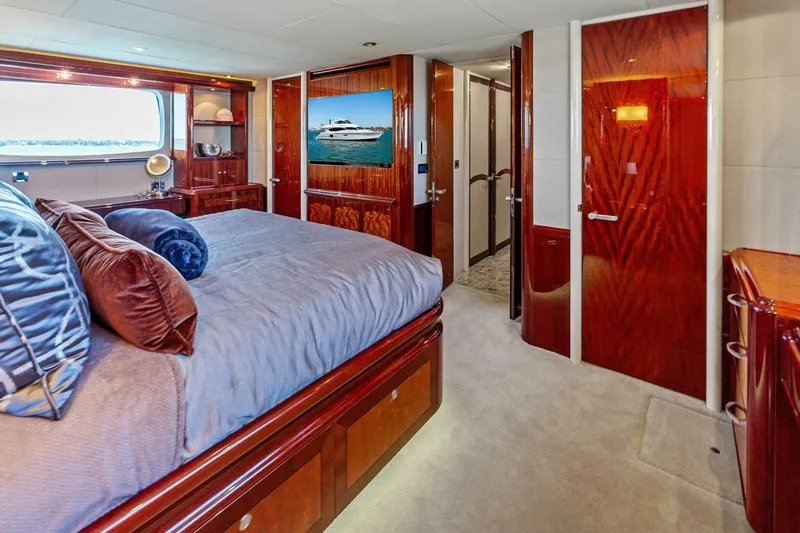 Summerwind Yacht Photos Pics Luxurious bedroom interior on 2005 Lazarra 80 yacht with elegant wood finishes.