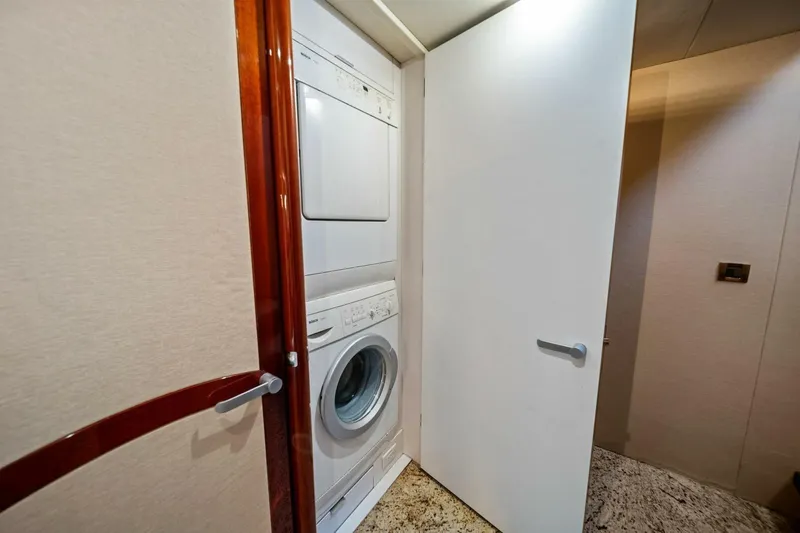 Summerwind Yacht Photos Pics Laundry area with stacked washer and dryer in 2005 Lazarra 80 yacht.