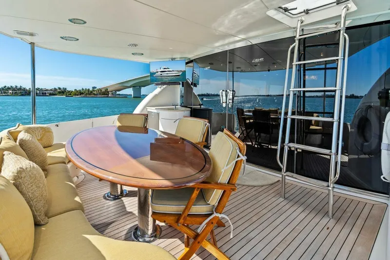 Summerwind Yacht Photos Pics Luxurious 2005 Lazarra 80 yacht deck with elegant seating, table, and ocean view.