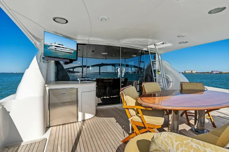 Summerwind Yacht Photos Pics Luxurious 2005 Lazarra 80 yacht deck with dining area and ocean view.