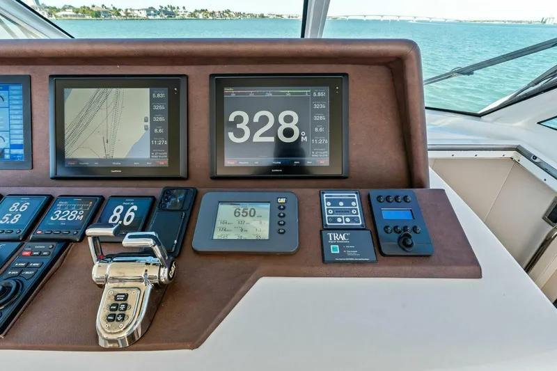 Summerwind Yacht Photos Pics Control panel of a 2005 Lazarra 80 yacht with navigation screens and controls.