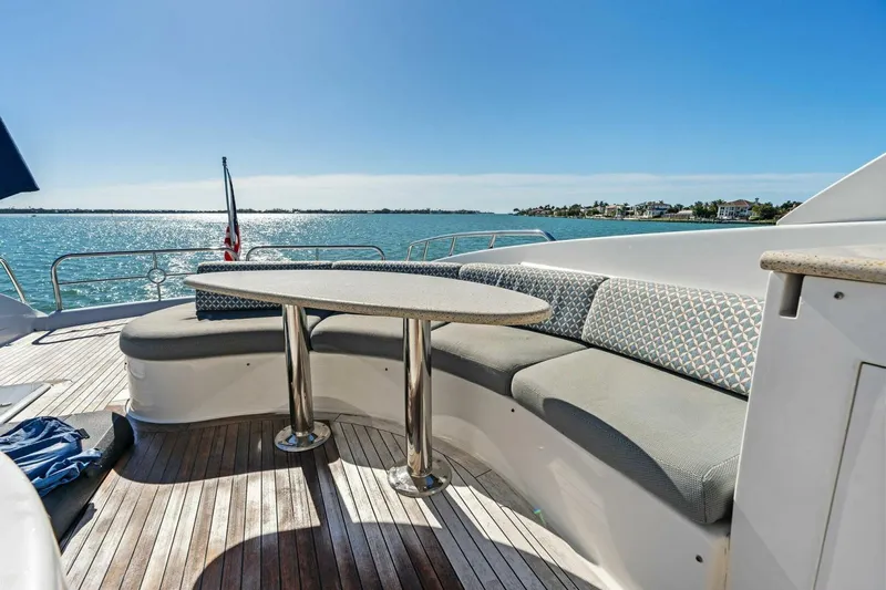 Summerwind Yacht Photos Pics Luxury 2005 Lazzara 80 yacht deck with seating, ocean view, and sunny sky.