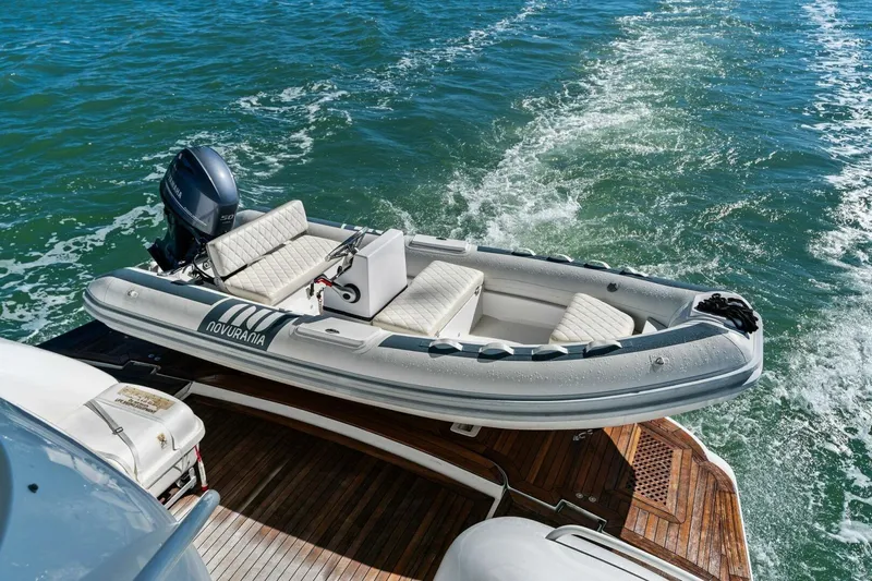 Summerwind Yacht Photos Pics Luxury yacht Lazarra 80 (2005) with Novurania tender on deck, cruising on open water.