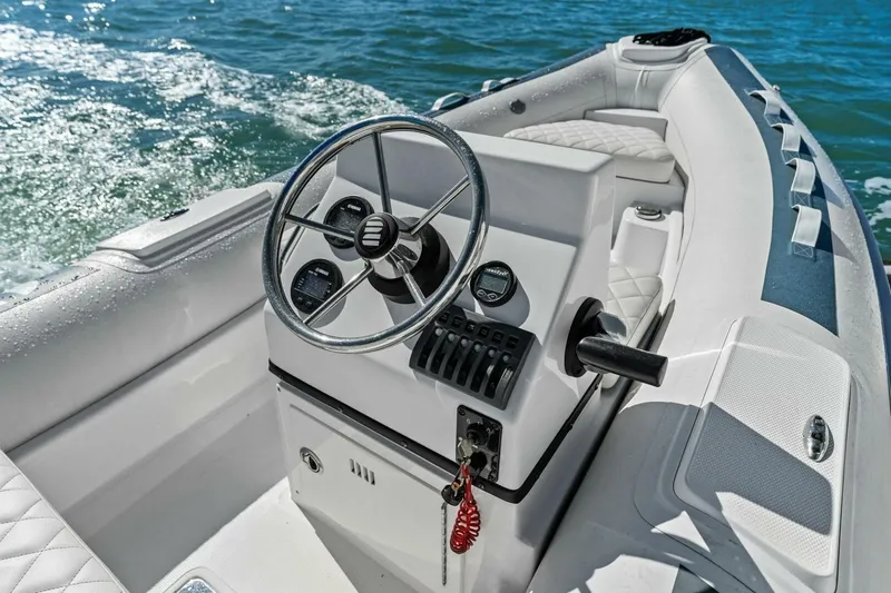 Summerwind Yacht Photos Pics 2005 Lazarra 80 boat cockpit with steering wheel and controls on open water.