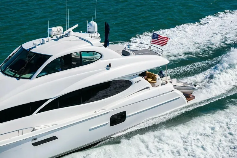 Summerwind Yacht Photos Pics Luxury 2005 Lazarra 80 yacht cruising on blue ocean with American flag.