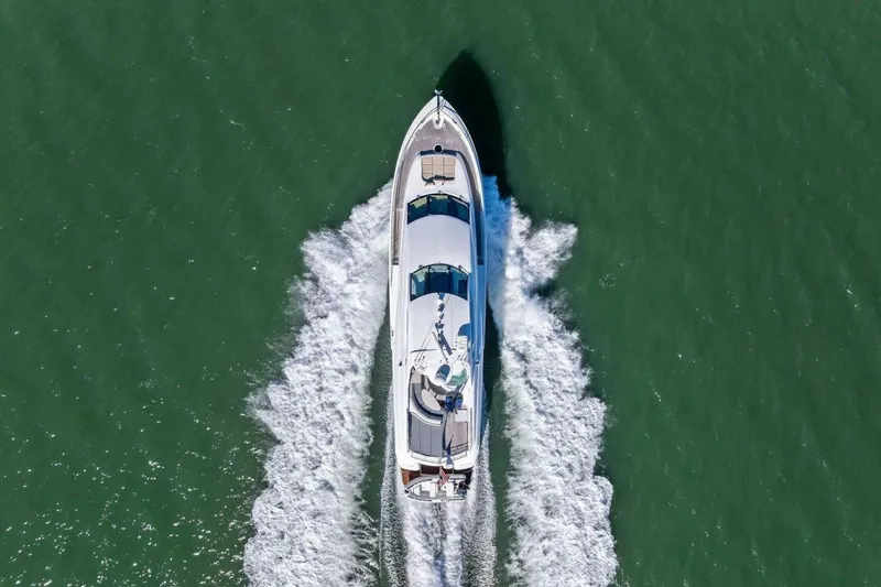 Summerwind Yacht Photos Pics Aerial view of 2005 Lazarra 80 yacht cruising on green water.