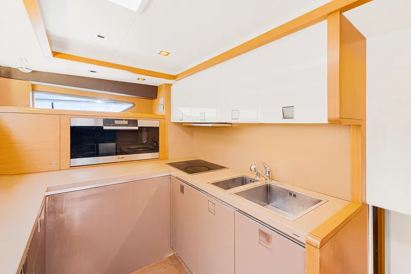 Papaito Yacht Photos Pics Modern kitchen interior on 2013 Ferretti Yachts 800, featuring sleek cabinetry and appliances.