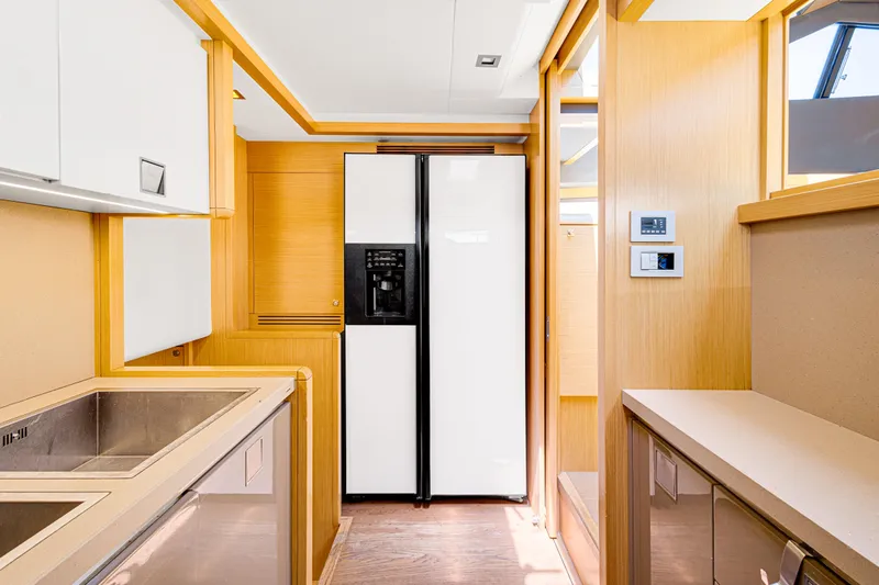 Papaito Yacht Photos Pics Modern kitchen interior of 2013 Ferretti Yachts 800, featuring sleek cabinetry and appliances.