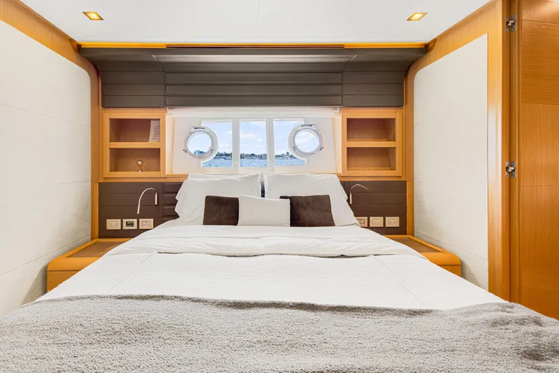 Papaito Yacht Photos Pics Luxurious bedroom interior of 2013 Ferretti Yachts 800 with ocean view portholes.