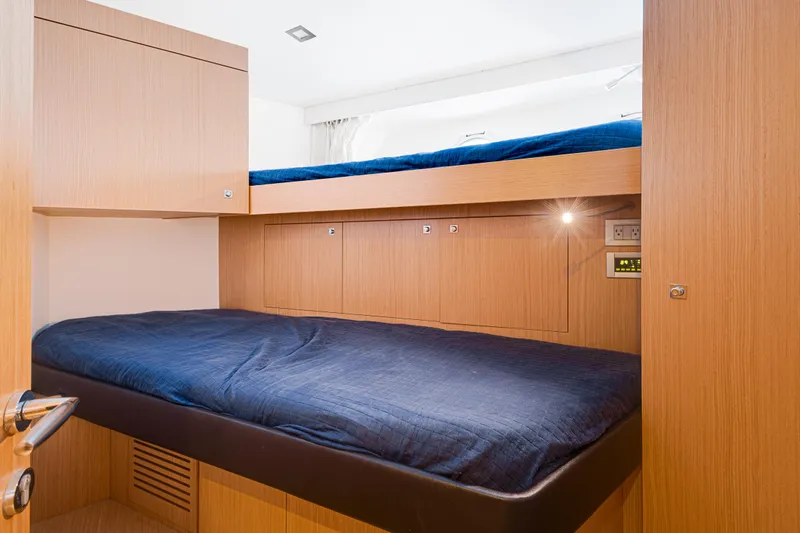 Papaito Yacht Photos Pics Bunk beds in 2013 Ferretti Yachts 800 cabin with wooden interior and blue bedding.