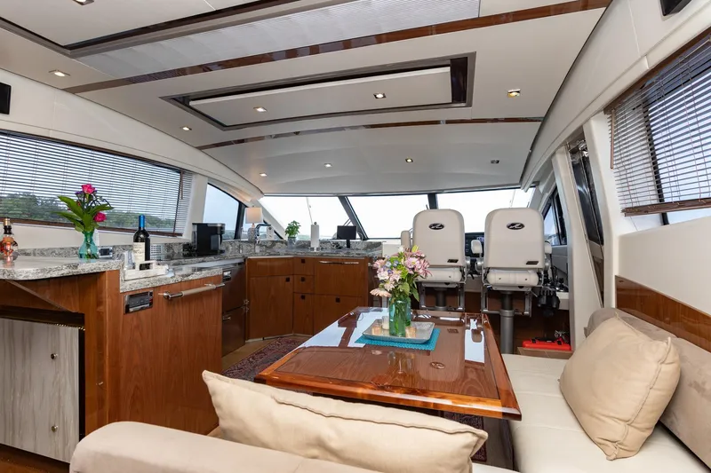 Janie Yacht Photos Pics Luxurious interior of 2018 Sea Ray L650 Fly yacht with elegant seating and modern amenities.