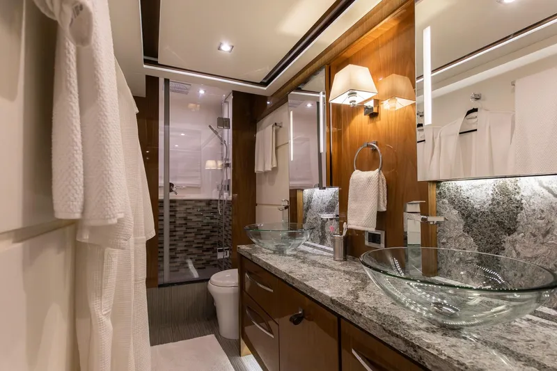 Janie Yacht Photos Pics Luxurious bathroom in 2018 Sea Ray L650 Fly yacht with glass sinks and elegant decor.