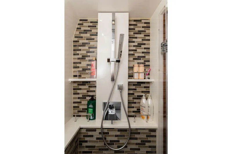 Janie Yacht Photos Pics Luxurious shower in 2018 Sea Ray L650 Fly yacht with modern fixtures and tiled walls.