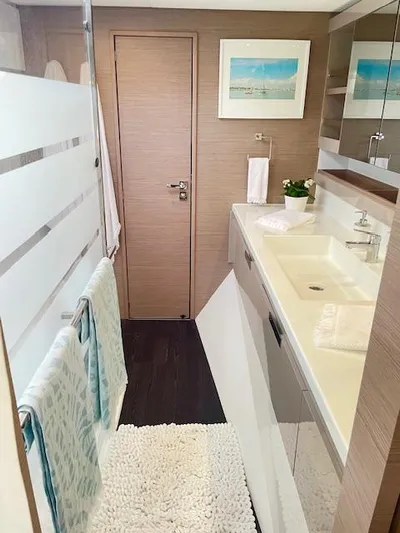 Moon Doggie Yacht Photos Pics Modern bathroom interior of 2022 Fountaine Pajot Tanna 47 yacht, featuring sleek design and amenities.