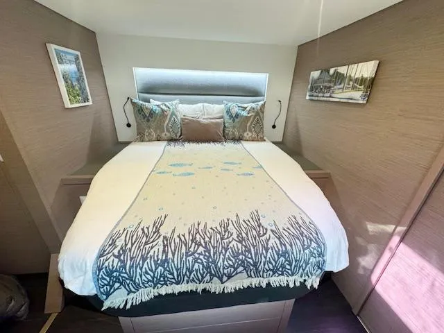 Moon Doggie Yacht Photos Pics Luxurious bedroom interior of 2022 Fountaine Pajot Tanna 47 yacht with elegant bedding.
