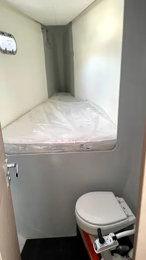 Moon Doggie Yacht Photos Pics Compact cabin with bed and toilet in 2022 Fountaine Pajot Tanna 47 yacht.