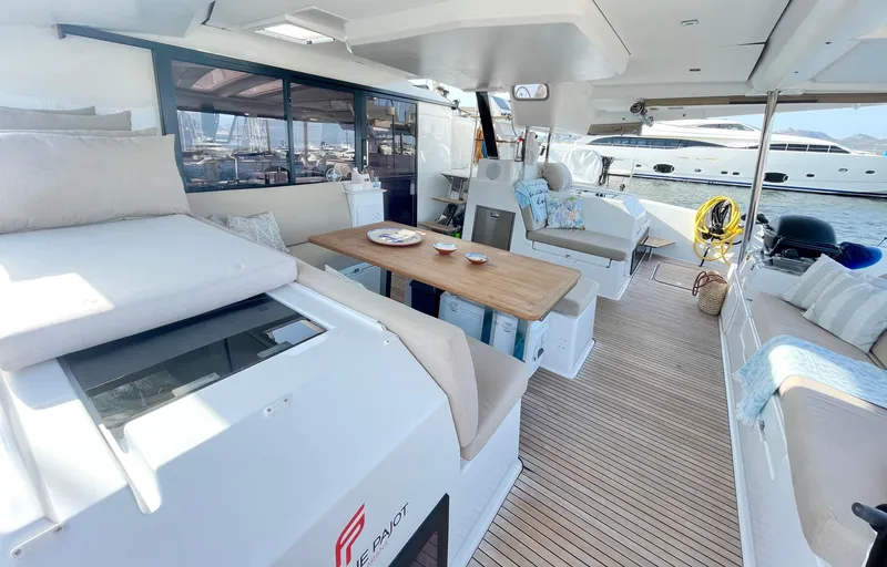 Moon Doggie Yacht Photos Pics Luxurious 2022 Fountaine Pajot Tanna 47 yacht interior with spacious seating and elegant dining area.