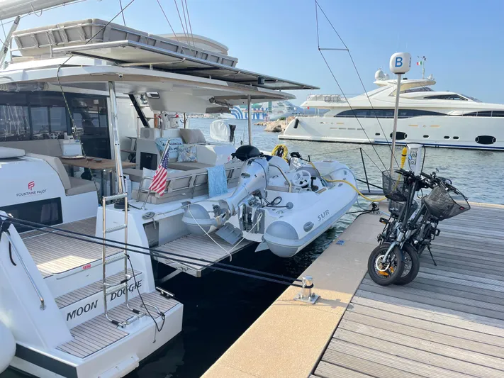 Moon Doggie Yacht Photos Pics 2022 Fountaine Pajot Tanna 47 yacht docked with dinghy and bicycles on deck.