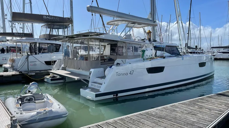 Moon Doggie Yacht Photos Pics 2022 Fountaine Pajot Tanna 47 catamaran docked at marina, surrounded by other boats.