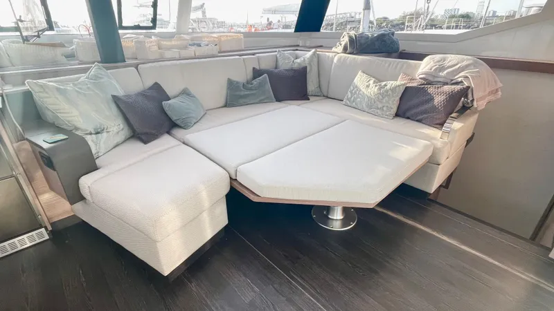 Moon Doggie Yacht Photos Pics Luxurious interior of 2022 Fountaine Pajot Tanna 47 yacht with plush seating and cushions.