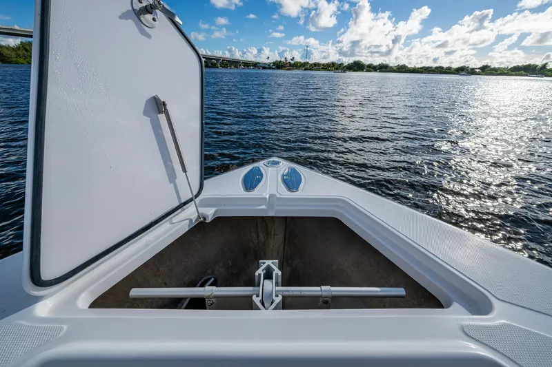 Checkered Flag Yacht Photos Pics Open storage compartment on 2011 Bahama 37 boat, overlooking calm water and blue sky.