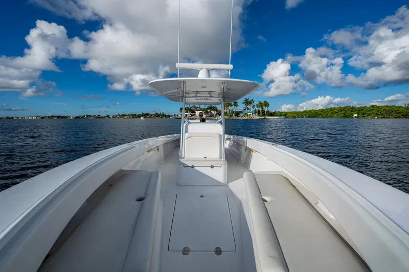 Checkered Flag Yacht Photos Pics 2011 Bahama 37 boat cruising on a sunny day with blue skies and clouds.