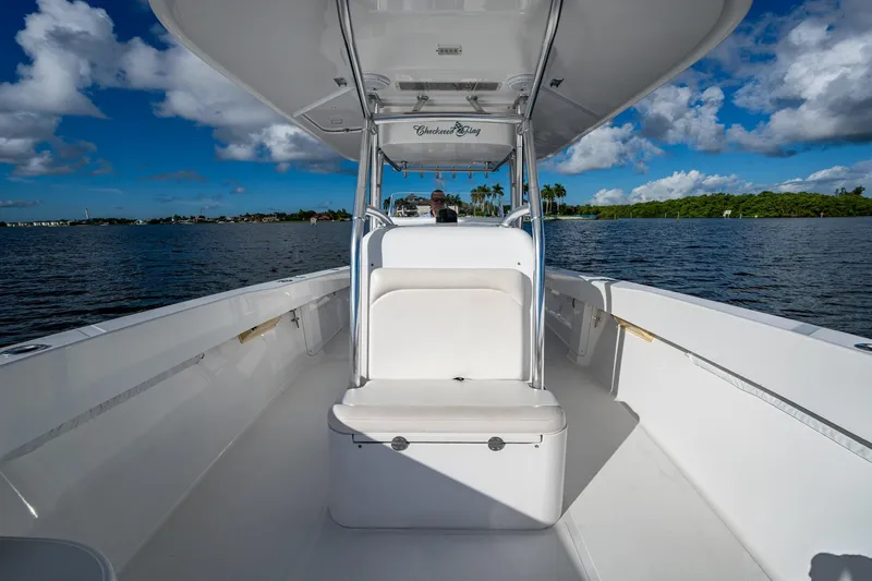 Checkered Flag Yacht Photos Pics 2011 Bahama 37 boat on calm water under a blue sky with clouds.