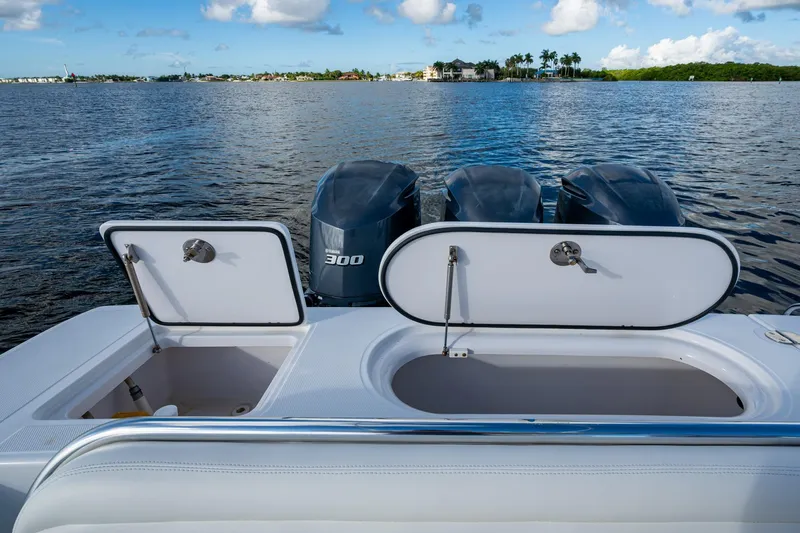 Checkered Flag Yacht Photos Pics 2011 Bahama 37 boat with open storage compartments and triple Yamaha 300 engines.