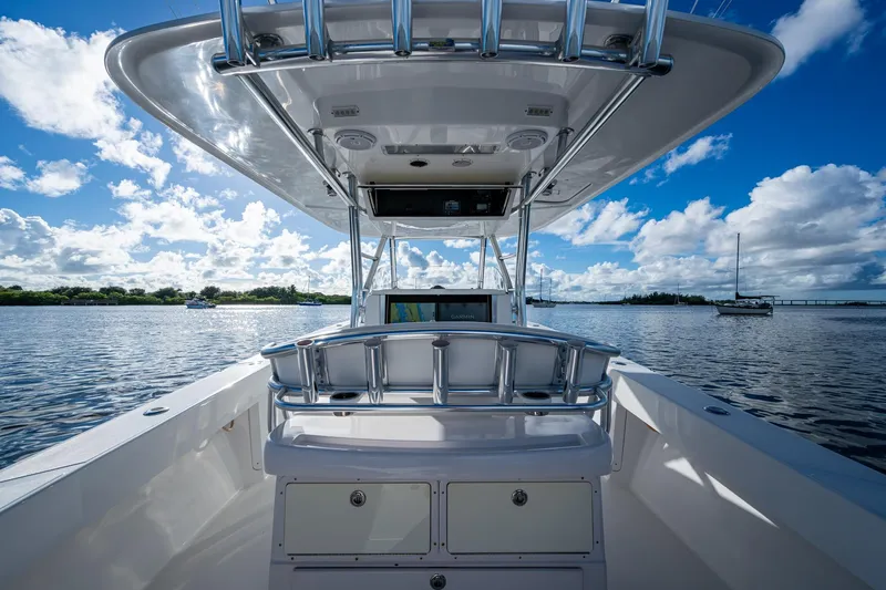 Checkered Flag Yacht Photos Pics 2011 Bahama 37 boat on calm water under a bright blue sky.