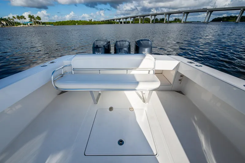 Checkered Flag Yacht Photos Pics 2011 Bahama 37 boat with bench seating, triple engines, and scenic waterway view.