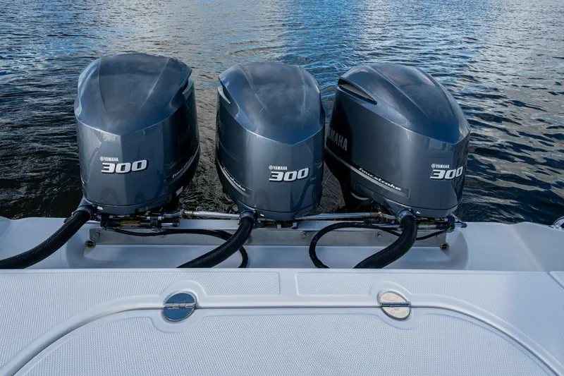 Checkered Flag Yacht Photos Pics Triple Yamaha 300 engines on a 2011 Bahama 37 boat, docked on water.