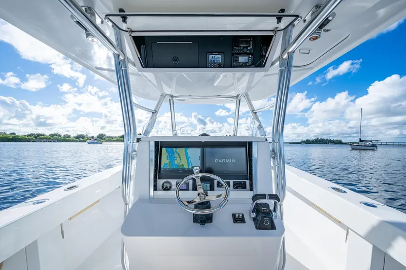 Checkered Flag Yacht Photos Pics Center console of 2011 Bahama 37 boat with Garmin navigation, on a sunny day.