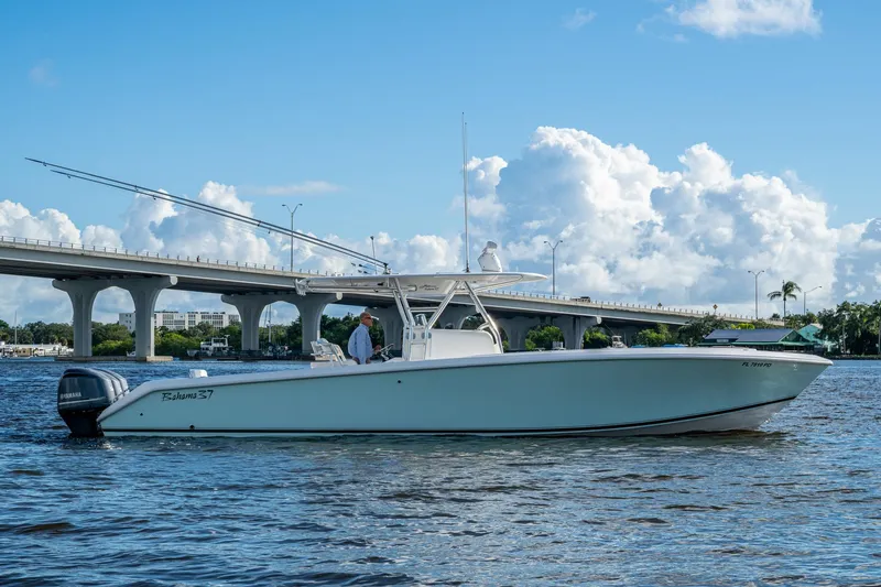 Checkered Flag Yacht Photos Pics 2011 Bahama 37 boat on water near a bridge under a blue sky.
