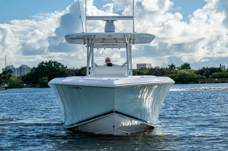 Checkered Flag Yacht Photos Pics 2011 Bahama 37 boat cruising on a sunny day with scenic waterfront backdrop.