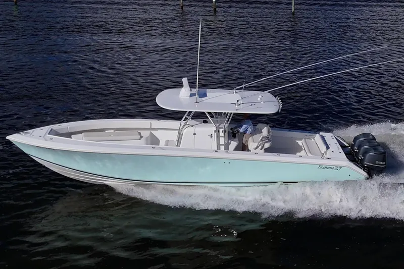 Checkered Flag Yacht Photos Pics 2011 Bahama 37 boat cruising on water with dual outboard engines.