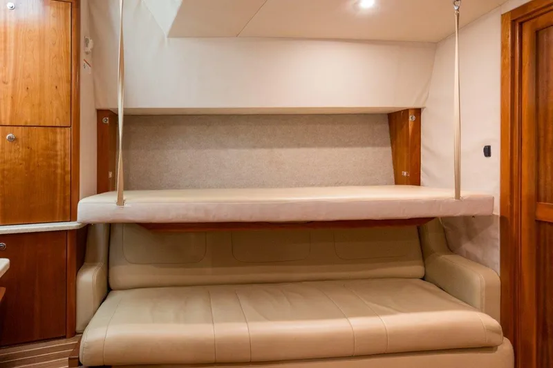 Tin Bender Yacht Photos Pics Interior of 2009 Albemarle 360 XF yacht with beige sofa and fold-down bunk.