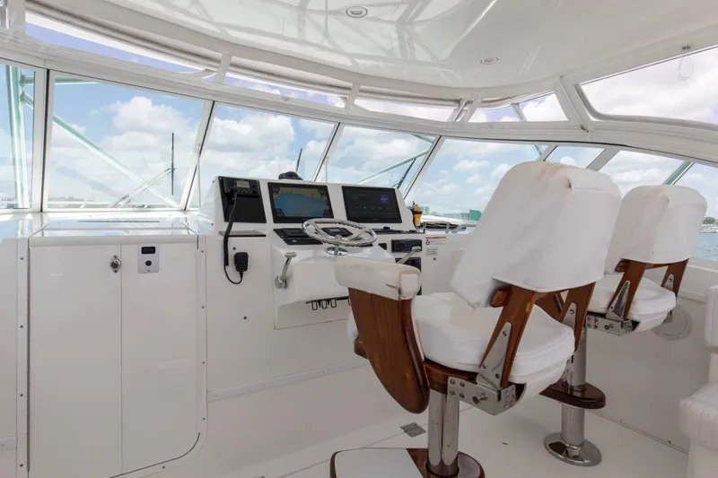 Tin Bender Yacht Photos Pics 2009 Albemarle 360 XF helm with white captain chairs and navigation equipment.