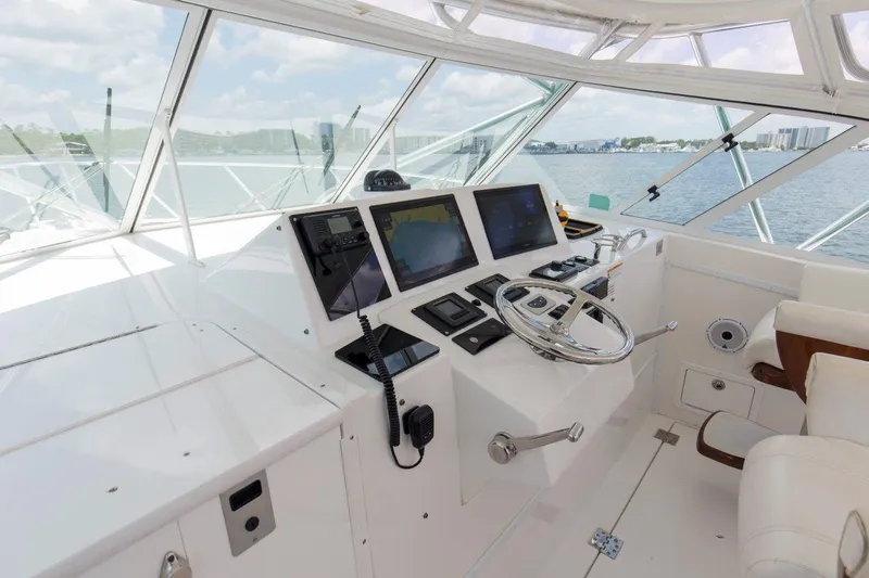 Tin Bender Yacht Photos Pics Helm of 2009 Albemarle 360 XF boat with modern navigation equipment and steering wheel.