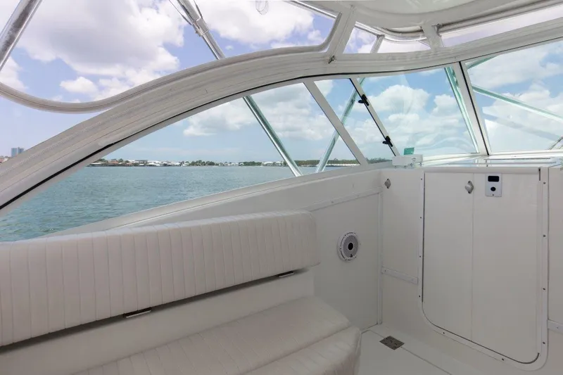 Tin Bender Yacht Photos Pics Interior view of 2009 Albemarle 360 XF boat with white seating and windows overlooking water.