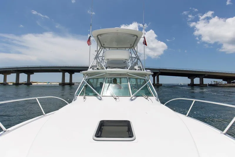Tin Bender Yacht Photos Pics 2009 Albemarle 360 XF boat cruising under a bridge on a sunny day.