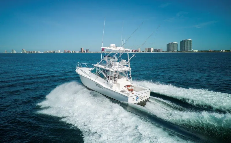 Tin Bender Yacht Photos Pics 2009 Albemarle 360 XF boat cruising on ocean near city skyline.