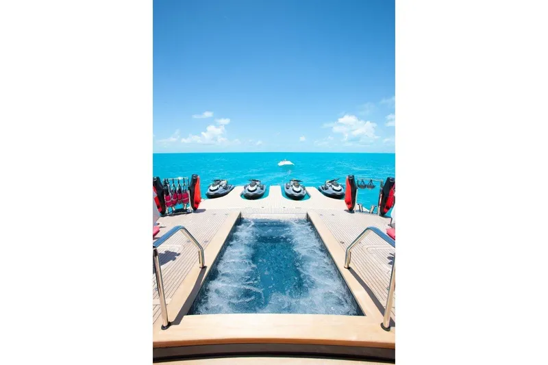 No Bad Ideas Yacht Photos Pics Luxurious Trinity Yachts 160, 2000 model, with pool and jet skis on turquoise ocean.