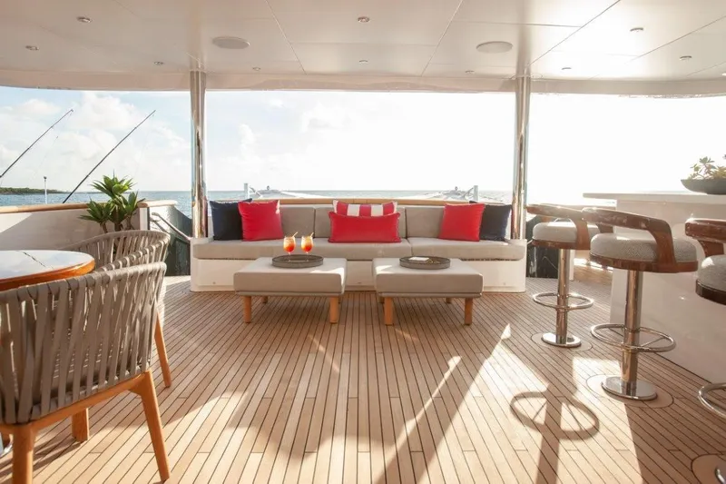 No Bad Ideas Yacht Photos Pics Luxurious Trinity Yachts 160 deck with elegant seating, bar stools, and ocean view.