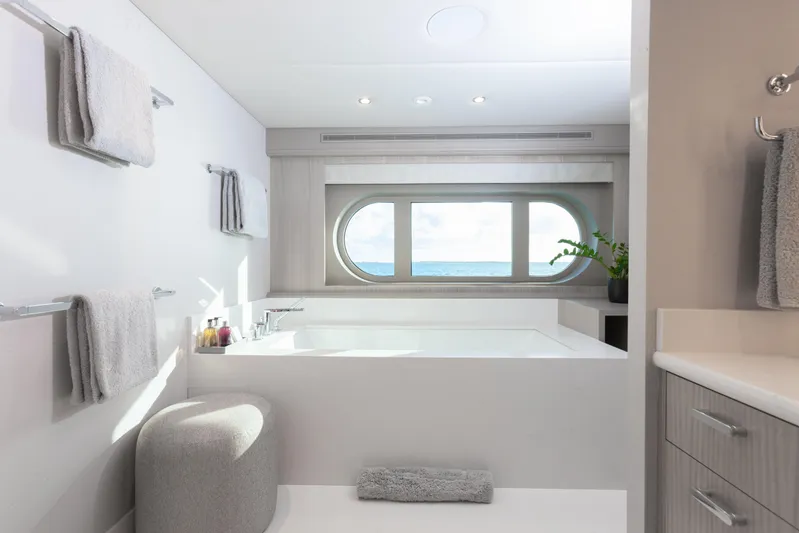 No Bad Ideas Yacht Photos Pics Luxurious yacht bathroom with ocean view, featuring modern design and elegant fixtures.